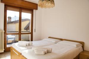 a bedroom with two beds and a large window at Cuor di Barzio P1 in Barzio