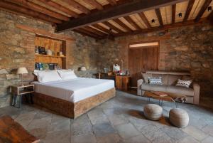 a bedroom with a bed and a couch at Lyhnos in Askas