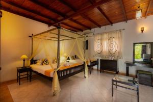 a bedroom with a canopy bed and a fireplace at Samadhi Yoga Resort in Bentota +21 photos