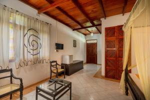 a living room with a couch and a table at Samadhi Yoga Resort in Bentota