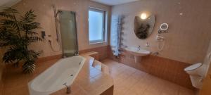 a bathroom with a tub and a toilet and a sink at Ferienwohnung Wille in Lünen +12 photos