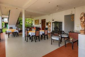 a dining room with tables and chairs at Samadhi Yoga Resort in Bentota