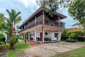 a house with a gambrel roof at Samadhi Yoga Resort in Bentota