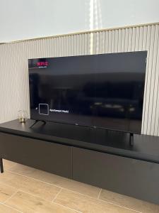 a flat screen tv sitting on top of a table at Brzostek Apartamenty in Marki