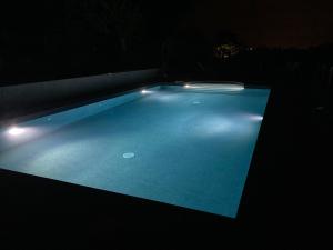 a swimming pool with lights in a dark room at Casa Vacanze immersa tra le colline, appartamento, vicinissima al mare e con nuova piscina in Senigallia +16 photos