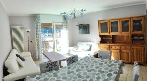 a living room with a bed and a couch at Azalea in Canazei