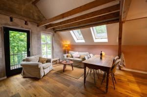 a living room with a table and a couch at Bed & Breakfast De Tol in Sint Annaland