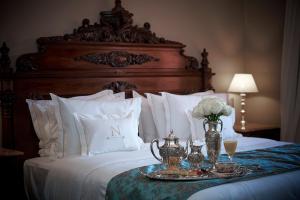 a bedroom with a large bed with a large wooden headboard at Nino Hotel Boutique in Asunción