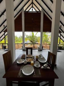 a dining room with a wooden table and chairs at Green Luxe in Dambulla