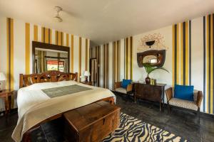a bedroom with a bed and a desk and a mirror at Casa Baga in Baga +50 photos