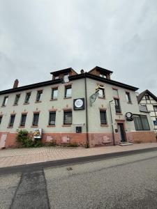 a large white building on the side of a street at RICLS Apartmenthaus Wurmberg - BRIGHT Collection in Wurmberg