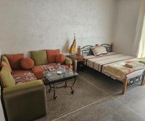 a living room with a couch and a couch and a table at Centre-ville rabat in Rabat