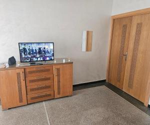 a room with a television on a dresser with a door at Centre-ville rabat in Rabat