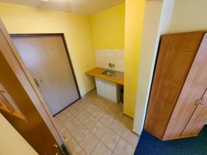 a small bathroom with a sink and a door at Ośrodek Szpulki in Zakopane +24 photos