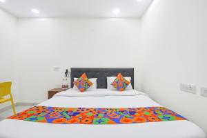a bedroom with a bed with a colorful blanket on it at FabHotel Resto Relax in New Delhi