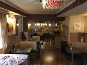 a restaurant with tables and chairs in a room at Classic Appartments in Knittelfeld