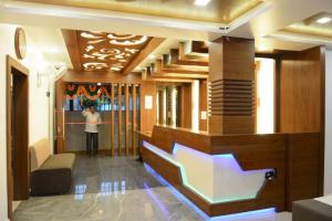 a person standing in a lobby with a stair case at Sri Shivam Hotel in Gondia