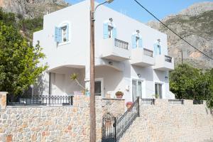 a white house on a stone wall at Skalia Mountain Sea Serenity in Kalymnos