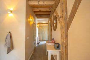 a hallway with a wooden beam in a house at Bed & Breakfast De Tol in Sint Annaland +107 photos