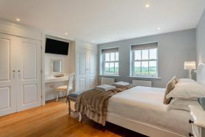a bedroom with a large bed and a desk at 4 Bed in Catterick oc-y33625 in Catterick Bridge