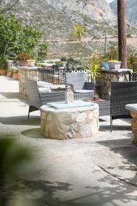 a patio with chairs and a table with a fountain at Skalia Mountain Sea Serenity in Kalymnos +2 photos