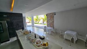a kitchen and dining room with a table and chairs at Hotel Almany in Palmas