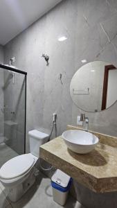 a bathroom with a sink and a toilet and a mirror at Hotel Almany in Palmas