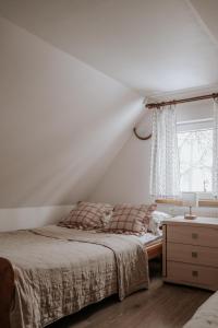 a bedroom with a bed and a window at Bogdanówka in Supraśl