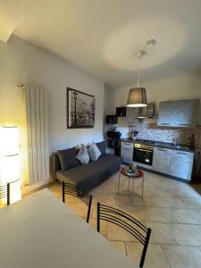 a living room with a couch and a table at Gioiello House in Pisa +17 photos