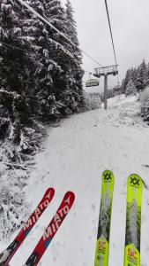 a pair of skis in the snow next to a ski lift at Sun Stream Apartment in Pamporovo