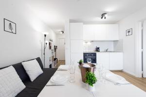 a white living room with a couch and a table at Haut de Monaco - Vue panoramique mer et ville - FE in Beausoleil