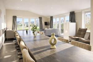 a living room with a long table and chairs at Group accommodation De Beemster with Sauna | 14 persons in West-Graftdijk