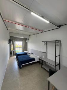 a room with three beds and shelves in it at Sierra Lages Hotel in Lages