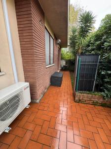 a brick walkway leading to a door of a house at Gioiello House in Pisa