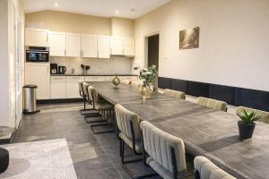 a large dining room with a long table and chairs at Group accommodation De Beemster with Sauna | 14 persons in West-Graftdijk