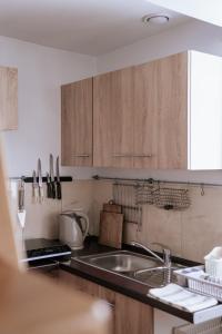 a kitchen with wooden cabinets and a sink at Bogdanówka in Supraśl +39 photos