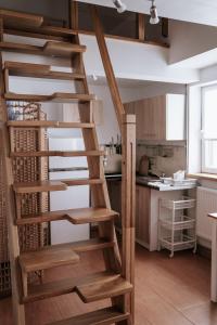 a wooden spiral staircase in a kitchen with a kitchen at Bogdanówka in Supraśl