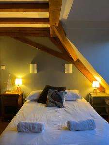 a bedroom with a bed with two pillows on it at Le Saint Michel in Otterswiller