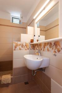 a bathroom with a sink and a mirror at Efthymia apartments in Faros +60 photos