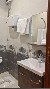 a bathroom with a sink and a mirror at شقق درة المصيف in Taif +13 photos