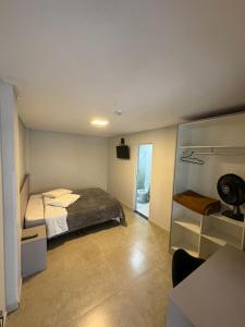 a bedroom with a bed and a room with a mirror at Sierra Lages Hotel in Lages +11 photos