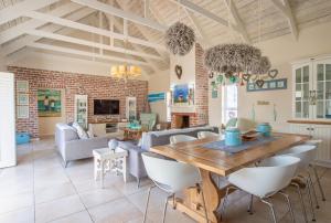 a living room with a wooden table and chairs at Beach House in Struisbaai