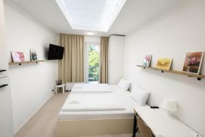 a room with two beds and a window at Bella Apartments Brno in Brno