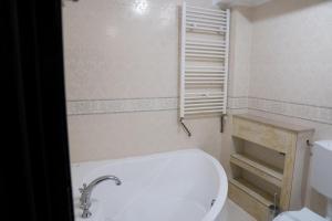 a white bathroom with a toilet and a sink at Hanul Simonului in Bran +22 photos