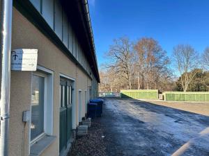 a side of a building with two trash cans next to it at Schlaffass in Neumark