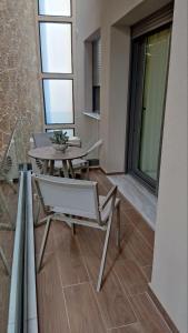 a dining room with a table and a chair at Olive City Suites in Larisa