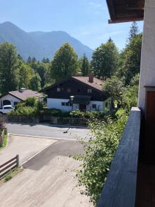 a view of a house with mountains in the background at Seelenbaumlerin in Schliersee +35 photos