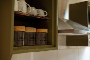 a cupboard with cups and mugs in a kitchen at StudioONE in Whitemark
