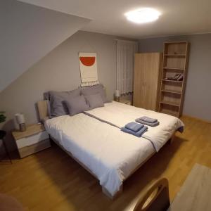 a bedroom with a large bed with two towels on it at Exigens House in Budapest