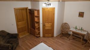 a living room with a couch and a chair at Готель Меридіан in Yasinya +7 photos